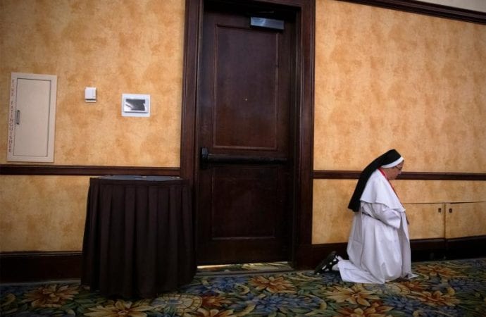 In a file photo, a woman religious prays Sept. 21, 2018, during the Fifth National Encuentro in Grapevine, Texas. (Credit: Tyler Orsburn/CNS.)