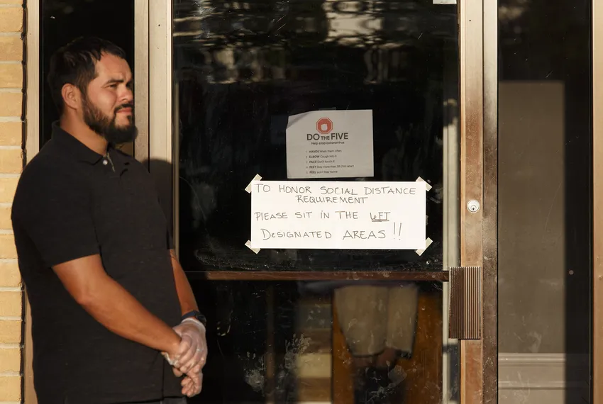 Worshippers arrived for a service Wednesday at City on a Hill Church in Houston. Rubber gloves were handed out, and a sign on the door asked people to sit 6 feet apart.