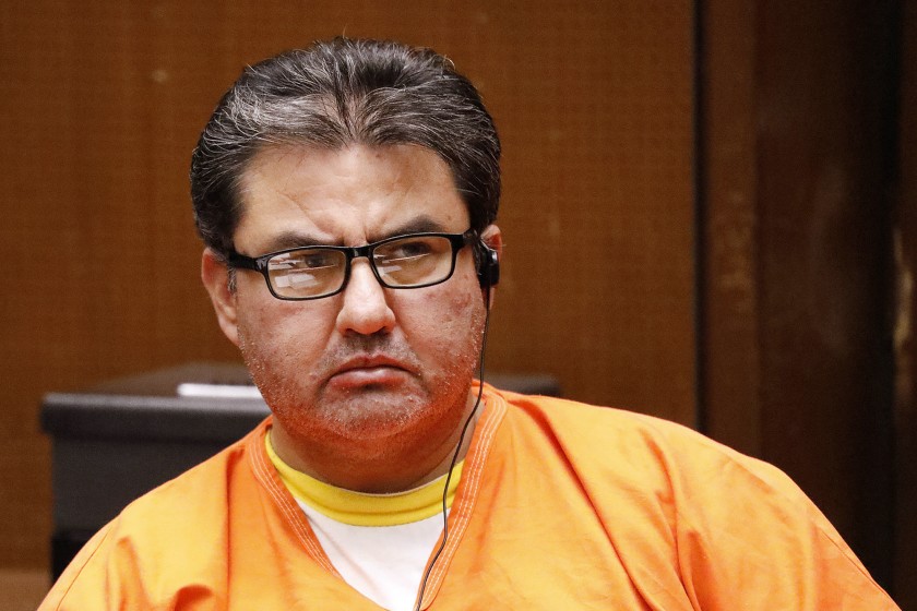 Naason Joaquin Garcia, the leader of the Guadalajara-based La Luz del Mundo church, listens to a court interpreter as he appears in Los Angeles County Superior Court in June. (Al Seib / Los Angeles Times)