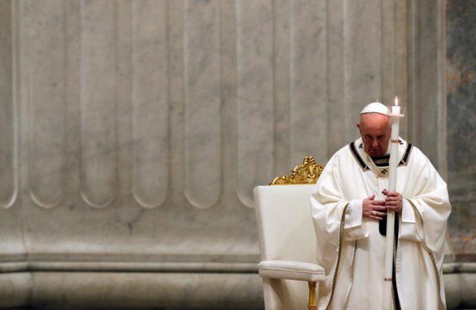 Pope Francis carries a candle at the start of the Easter vigil in St. Peter's Basilica at the Vatican April 11, 2020. (Credit: Remo Casilli/Reuters via CNS.)