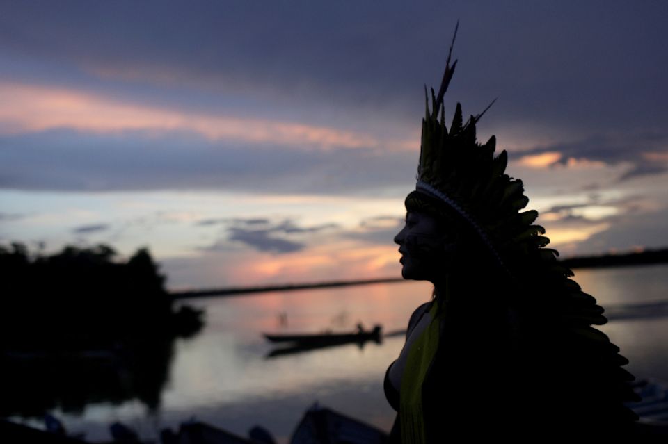 A leader of the Celia Xakriaba peoples walks along the banks of the Xingu River in Brazil's Xingu Indigenous Park Jan. 15. (CNS/Reuters/Ricardo Moraes)