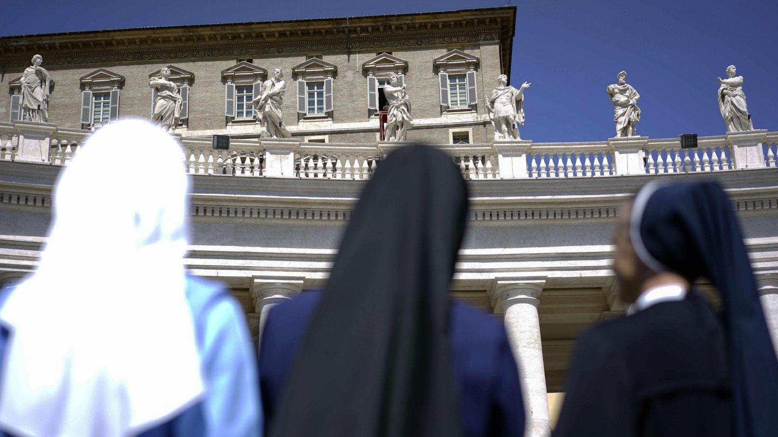 Nuns look up at Pope Francis delivering his blessing during the Regina Coeli prayer he celebrated from the window of his studio overlooking St.Peter’s Square, at the Vatican, on April 21, 2014. (AP Photo/Andrew Medichini)