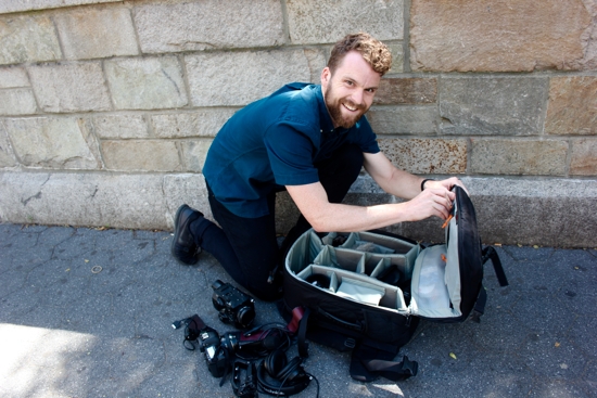 Hunter Johnson assembles a video camera and audio gear in July 2019 before interviewing people in a New York City park for a Human Rights Watch video project. Johnson more recently was commissioned to make a documentary on restorative justice efforts in the Archdiocese of St. Paul and Minneapolis. COURTESY Hunter Johnson