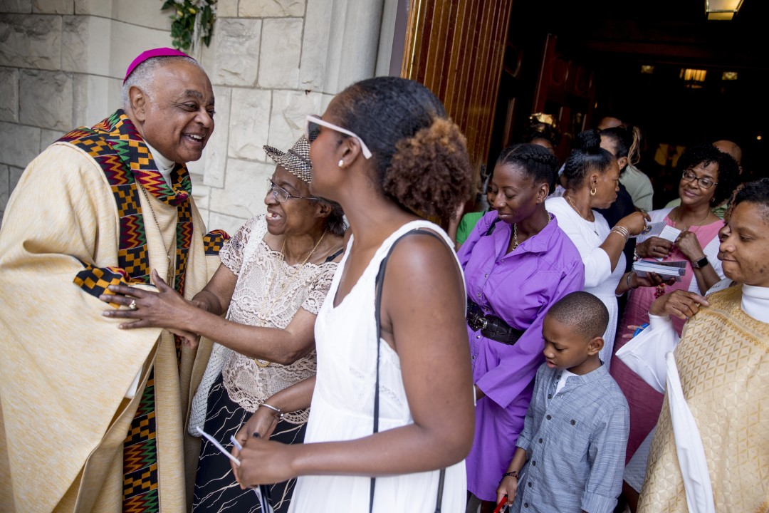 Archbishop Wilton Gregory, left, greets parishioners after Mass at St. Augustine Catholic Church in Washington, D.C.(Andrew Harnik / Associated Press)
