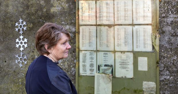 Catherine Corless looks at the list of names at the Tuam mother and baby home burial ground. Photograph: Joe O’Shaughnessy