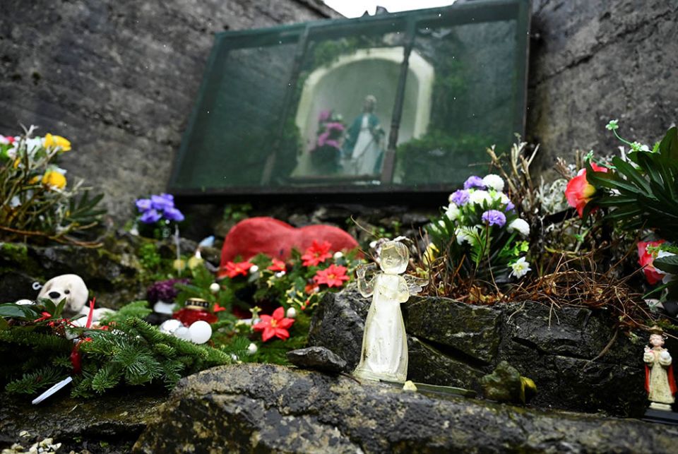An angel and statue of Mary are pictured at a cemetery in Tuam, Ireland, where the bodies of nearly 800 infants were uncovered at the site of a former Catholic home for unmarried mothers and their children. The photo was taken Jan. 12, the day a commission investigating the treatment of women in such homes released its report. (CNS/Clodagh Kilcoyne, Reuters)