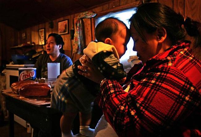 Elias Pete Jr. and Priscilla Otten with her baby, Steve, February 2005. Photo by Damon Winter.