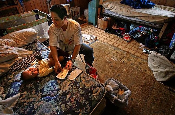 Elias Pete Jr. with his son, February 2005. Photo by Damon Winter.