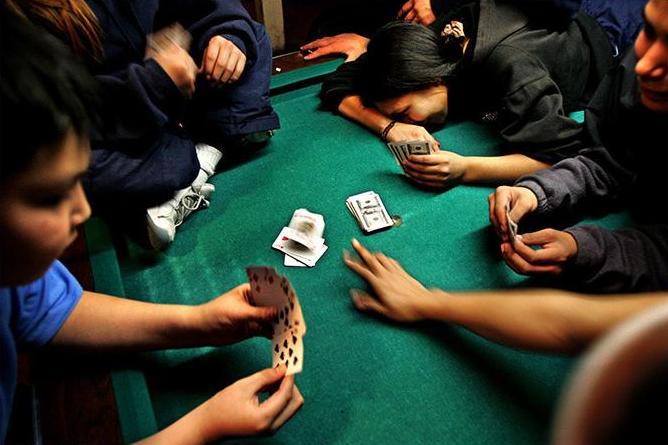 Children playing cards at Liberty Cafe in St. Michael AK, February 2005. Photo by Damon Winter.