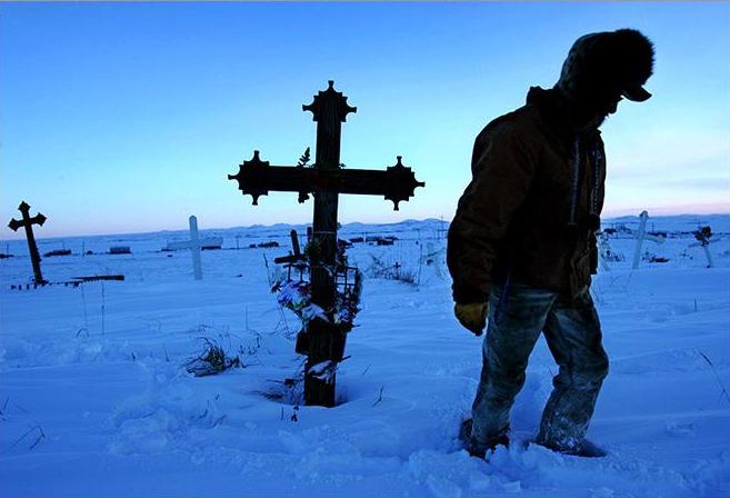 Thomas Cheemuk visits his brother John's grave in St. Michael AK, February 2005. Photo by Damon Winter.