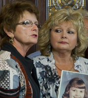 Kim Schmit of Willmar watches her mother, Jan Hazen of New London, on Monday, Sept. 16, 2013, tell about the day Kim came home as a youngster and told her about being abused by a priest. (Forum News Service photo by Don Davis)