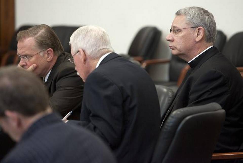 Bishop Robert Finn (right) of the Diocese of Kansas City-St. Joseph in his 2012 trial, which resulted in a misdemeanor conviction of failing to report suspicions of child abuse.TAMMY LJUNGBLAD/THE KANSAS CITY STAR