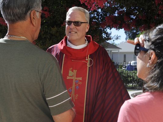 Rev. Eric Swearingen, pastor of the Catholic Church of Visalia, greet parishioners after Mass at St. Mary's on June 28, 2014. He is the new pastor of the Catholic Church of Visalia.