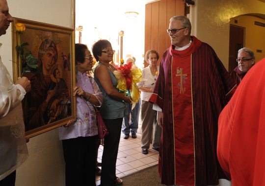 Rev. Eric Swearingen prepares to bless an image of Our Lady of Perpetual Help before Mass June 28, 2014 at St. Mary's Catholic Church. He is the new pastor of the Catholic Church of Visalia. (Photo: Teresa Douglass )