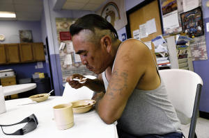 Martin Etcitty from the Lake Valley Chapter eats dinner Wednesday at Catholic Charities in Farmington. (Jon Austria — The Daily Times)