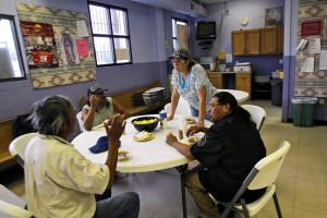 Volunteer Amy Pritchard, center, of the First Baptist Church in Bloomfield, takes orders from clients Wednesday during dinner at Catholic Charities in Farmington. (Jon Austria — The Daily Times)