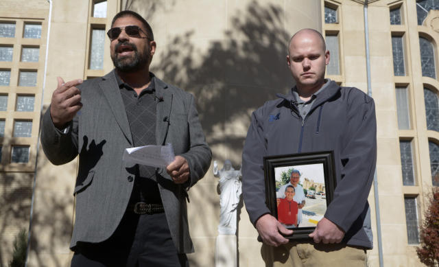 Brian Gutierrez of Albuquerque, left, and Ken Wolter of Detroit identify themselves as John Doe C and D, who filed lawsuits last year against the Archdiocese of Santa Fe alleging they were sexually abused as children by priests in Albuquerque. Wolter holds a photo of himself at age 11 or 12 standing with his alleged abuser, Arthur Perrault, a former pastor of St. Bernadette Parish. (Greg Sorber/Albuquerque Journal)