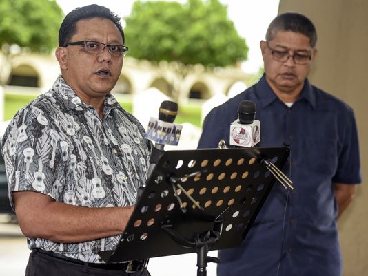Roland Sondia, left, of Agat, Guam, responds to a question during a press conference Sept. 22, 2016. Sondia made a public appeal to Gov. Eddie Calvo to pass Bill 326 that would remove the statute of limitations on civil suits regarding sexual abuse of children.