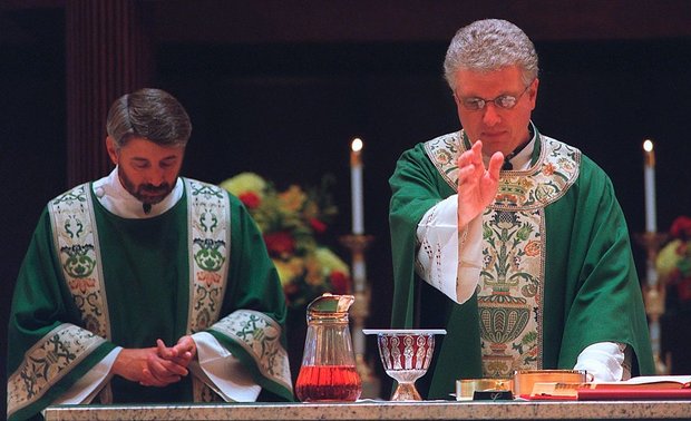 Rev. Paul Angelicchio (right), conducts a Mass at Holy Family Church in Fairmount in October 2003. This week the Syracuse Catholic Diocese put The Rev. Paul F. Angelicchio, pastor of St. John the Baptist and Transfiguration parish in Rome, on administrative leave as church officials investigate an allegation of abuse involving a minor 27 years ago. (Gary Walts | Syracuse.com, file photo, 2003)
