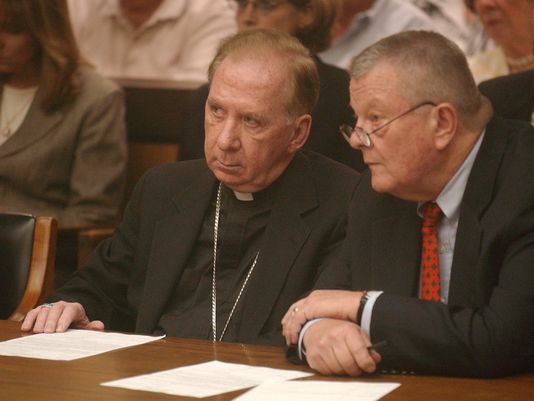 Bishop Thomas O'Brien (left), the former head of the Roman Catholic Diocese of Phoenix, and his attorney Tom Henze listen to Maricopa County Superior Court Judge Eddward Ballinger on July 7, 2003, during O'Brien's arraignment in a fatal hit-and-run.