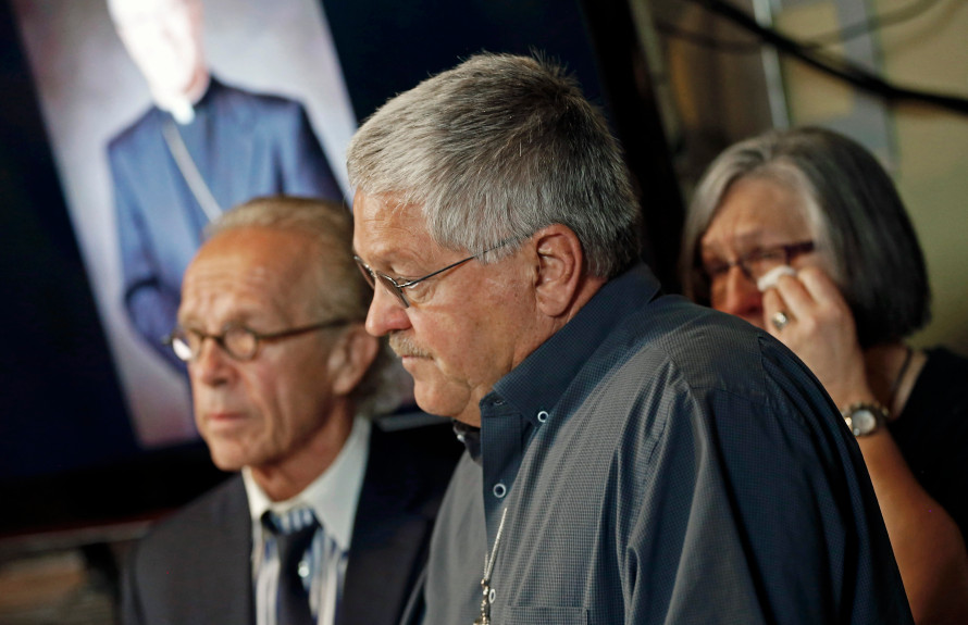 Ron Vasek, center, talks of the alleged sex abuse cover-up he suffered while addressing a news conference along with his wife Patty, right, and attorney Jeff Anderson, left, Tuesday, May 9, 2017, in St. Paul. Anderson announced a lawsuit against Bishop Michael Hoeppner of Crookston, Minn., accusing the bishop and diocese of concealing a report of abuse and threatening retaliation against Vasek if he went public. (Jim Mone / Associated Press)
