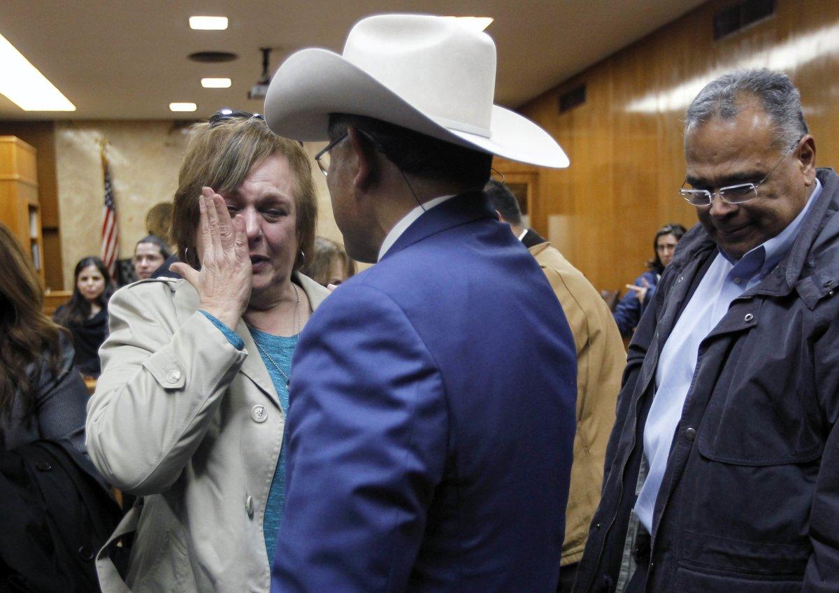 Garza's relative Noemi Sigler cries while talking with Texas Ranger Rudy Jaramillo (c.) following Feit's conviction. (NATHAN LAMBRECHT/AP)