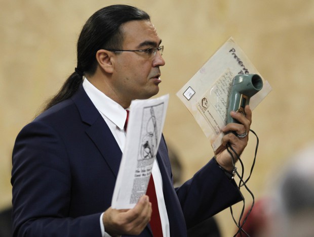 Nathan Lambrecht, The Monitor via APDefense attorney O. Rene Flores holds a slide viewer and statements as he presents his closing argument John Feit’s murder trial, Thursday, Dec. 7, 2017, at the Hidalgo County Courthouse in Edinburg, Texas. Feit, a former priest, is accused of suffocating Irene Garza in April 1960, after she went to confession at Sacred Heart Catholic Church in McAllen.