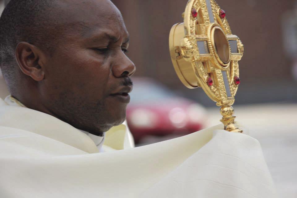 Father Deusdedit Mulokozi leads a Catholic procession in 2014 in Sedalia. The Diocese of Jefferson City expelled Mulokozi in 2015 after a 15-year-old girl reported he had hugged her inappropriately during a counseling session at Sacred Heart Church.