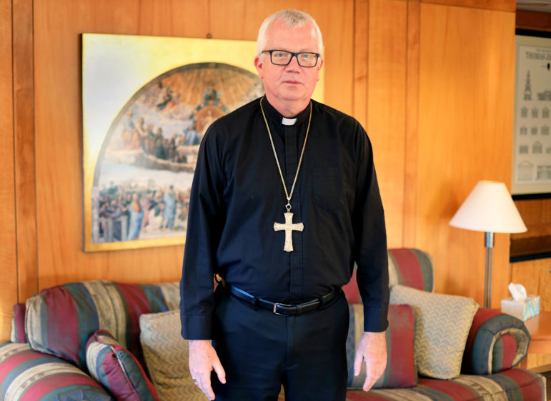 Bishop Donald Hying stands in his office at the Catholic Diocese of Madison in Madison, Wis., on Oct. 23, 2019. Soon after being installed as bishop in June, Hying spoke with Patricia Gallagher Marchant about the abuse she endured as a child in the diocese in 1965. Says Hying: “My door and heart are always open for speaking with victims as they may feel the need to come forward and speak.”