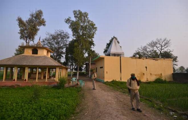Police personnel stand guard near the temple where the alleged gang rape occurred at Mevli village in Budaun, U.P. | Photo Credit: R.V. MOORTHY
