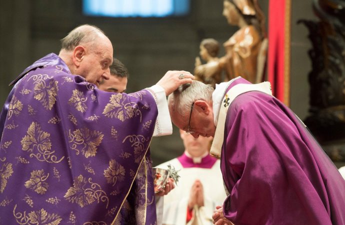 Cardinal Angelo Comastri, left, places the ashes on the head of Pope Francis during the Ash Wednesday mass, in St. Peter's Basilica at the Vatican, Wednesday, Feb. 10, 2016. (Credit: L'osservatore Romano / Pool Photo via AP.)