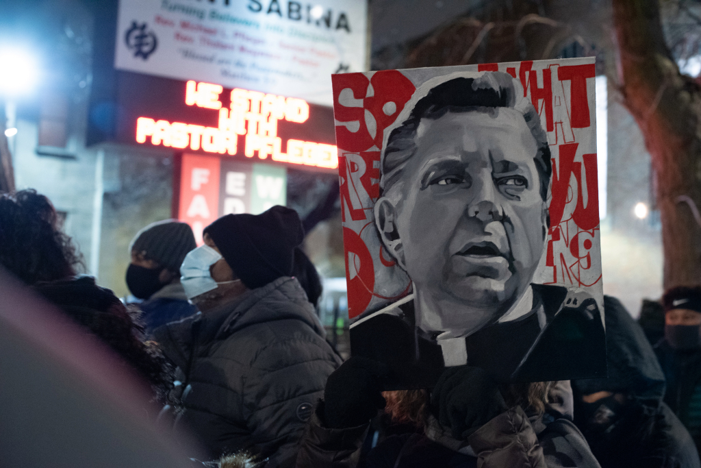 A person holds a painting of Rev. Michael Pfleger as members of the faith community rally in the Auburn Gresham neighborhood on January 8, 2021 the week Pfleger was removed from his post at Saint Sabina while a decades-old sex abuse allegation is investigated. Colin Boyle, Block Club Chicago