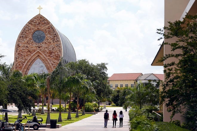 Patrons are seen on campus near the iconic Quasi Parish Ave Maria Oratory Tuesday, May 12, 2015, at Ave Maria University in Ave Maria. Corey Perrine / Naples Daily News