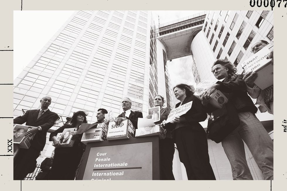 Survivors holding boxes containing documents alleging decades of systemic cover-up of sexual abuse. They are gathered in front of the International Criminal Court in The Hague.