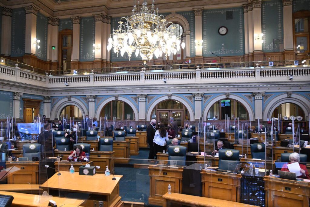 Legislators work in the House Chamber at the Capitol in Denver on the second day of the 73rd General Assembly of the Colorado State Legislature on Jan. 14, 2021.