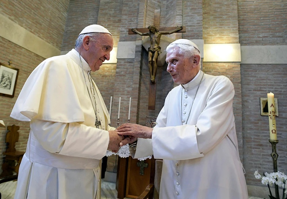 In this June 28, 2017, file photo, Pope Francis, left, and Pope Benedict XVI meet each other on the occasion of the elevation of five new cardinals at the Vatican. (L’Osservatore Romano/Pool photo via AP, File)