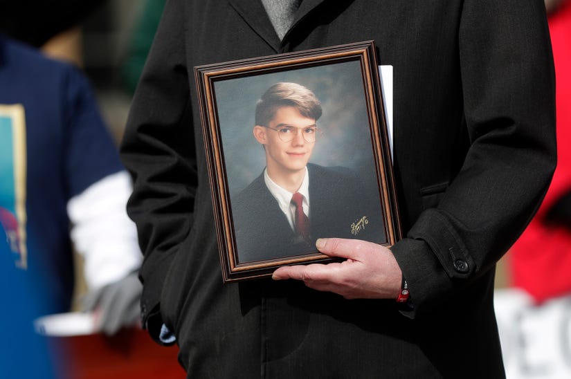 A photo of Nate Lindstrom, who died by suicide at age 45 after suffering from clergy abuse as a child, is held during a memorial rally held outside Green Bay Notre Dame on March 7, 2021, in Green Bay, Wis. Sarah Kloepping/USA TODAY NETWORK-Wisconsin