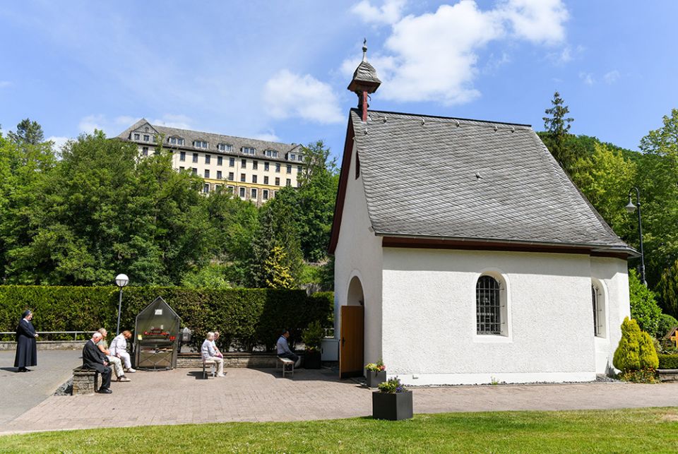 Pilgrims pray in front of the original Schonstatt Shrine in Vallendar, Germany, May 21, 2020. German Bishop Stephan Ackermann of Trier has ordered the reexamination of abuse allegations against Fr. Joseph Kentenich, founder of the Schonstatt movement, from his time in exile in the U.S. (CNS/Harald Oppitz, KNA)