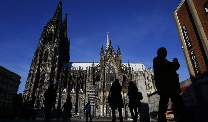 People are silhouetted against the Cologne Cathedral in Germany in 2016. (CNS/Reuters/Wolfgang Rattay)