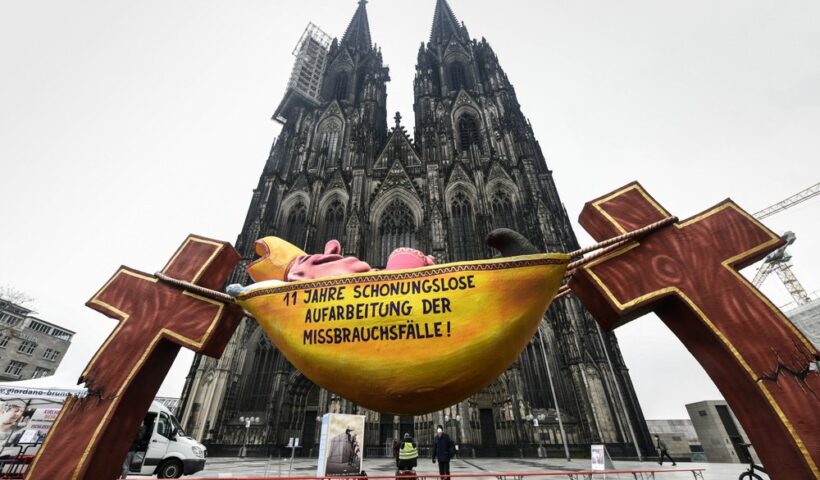 A carnival float depicting a sleeping Cardinal, reading '11 years of relentless processing of cases of abuse' is set in front of the Cologne Cathedral to protest against the Catholic Church in Cologne, Germany, Thursday, March 18, 2021. Faced with accusations of trying to cover up sexual violence in Germany's most powerful Roman Catholic diocese, the archbishop of Cologne Cardinal Rainer Maria Woelki publishes an independent investigation. (AP Photo / Martin Meissner)