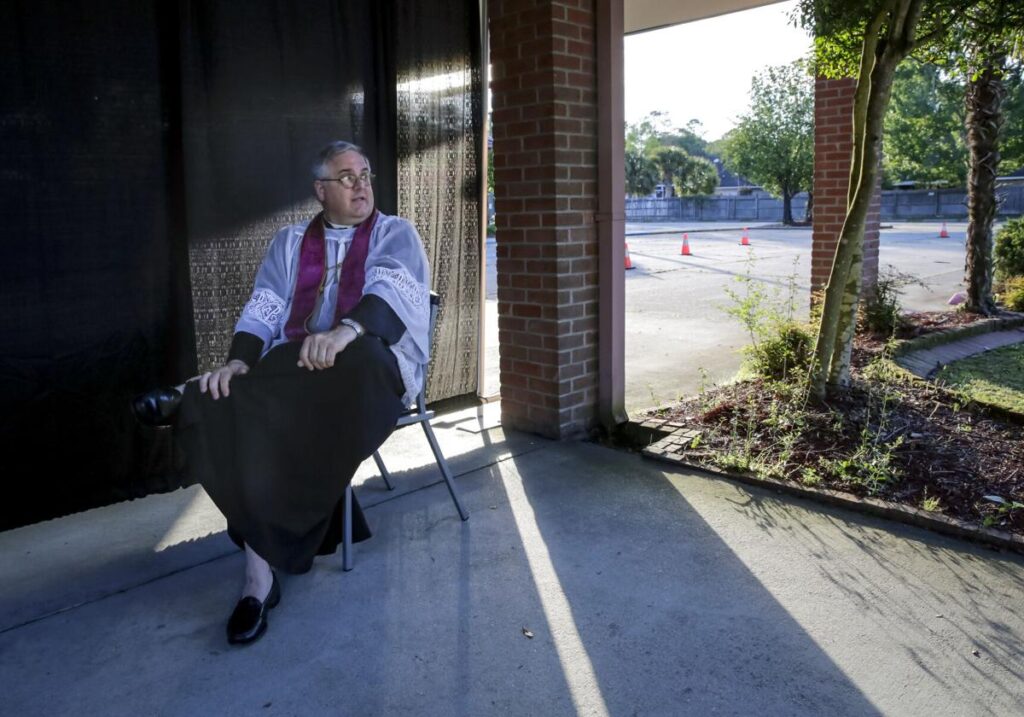 The Rev. Pat Wattigny of St. Luke the Evangelist Catholic Church in Slidell holds a drive-up confessional Wednesday, April 1, 2020, one of the changes the church has made due to the coronavirus pandemic.