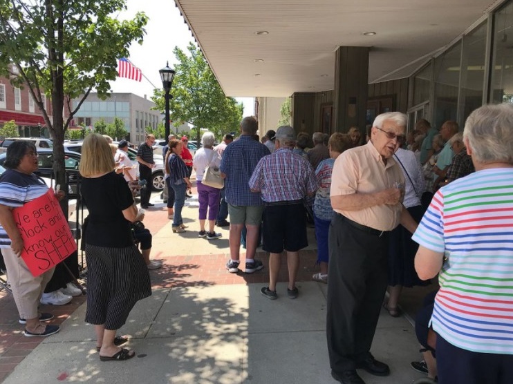 Demonstrators gather in front of the downtown Bay City law office of attorney Matthew L. Reyes on the afternoon of July 24, 2019, to show their support for the Rev. Dennis H. Kucharczyk.