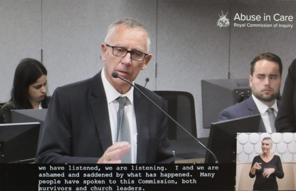 Cardinal John Dew of Wellington, New Zealand, is pictured in a screenshot speaking March 22, 2021, at a hearing of the New Zealand Royal Commission on Abuse in Care in Auckland. The royal commission directed that no attendees at public hearings should wear religious attire or uniforms, as that could be triggering for abuse survivors. (Credit: CNS screenshot/NZ Catholic.)