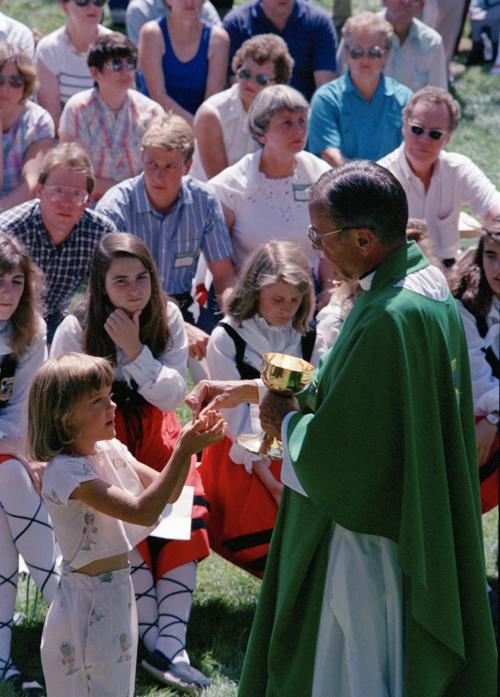 In this Sept. 19, 1988, file photo the Rev. Joseph Hart dispenses communion during an outdoor Mass celebrated for participants of the Basque Festival in Buffalo.   Dean Wariner, AP