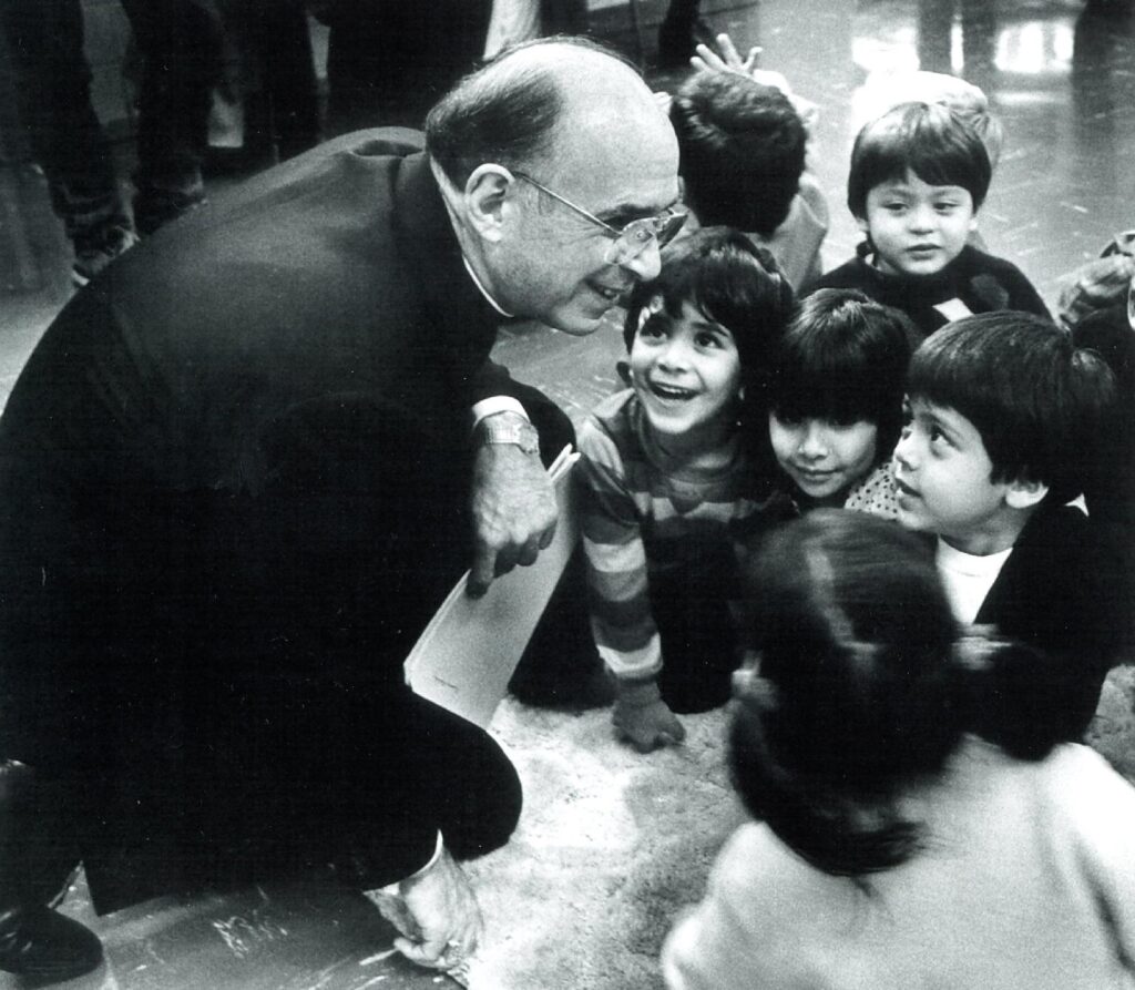 The late Chicago Cardinal Joseph L. Bernardin is pictured with children in an undated photo. Over a two-year period, in 1991 and 1992, the cardinal developed a comprehensive plan to address clergy sexual abuse and shared the plan with his fellow bishops, Cardinal Blase J. Cupich, Chicago's current cardinal-archbishop, said in an April 9, 2021, address for an international symposium on clergy sex abuse. (CNS photo/courtesy John H. White)