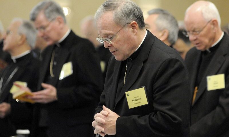 FILE - In this Monday, Nov. 10, 2008 file photo, Bishop Michael J. Hoeppner of Crookston, Minn. prays during a semi-annual meeting of the United States Conference of Catholic Bishops, in Baltimore. A Minnesota bishop who was investigated by the Vatican for allegedly interfering with past investigations into clergy sexual abuse has resigned. The Vatican said Tuesday, April 13, 2021 that Pope Francis had accepted the resignation of Crookston Bishop Michael Hoeppner and named a temporary replacement to run the dioceses. (AP Photo/ Steve Ruark, File)