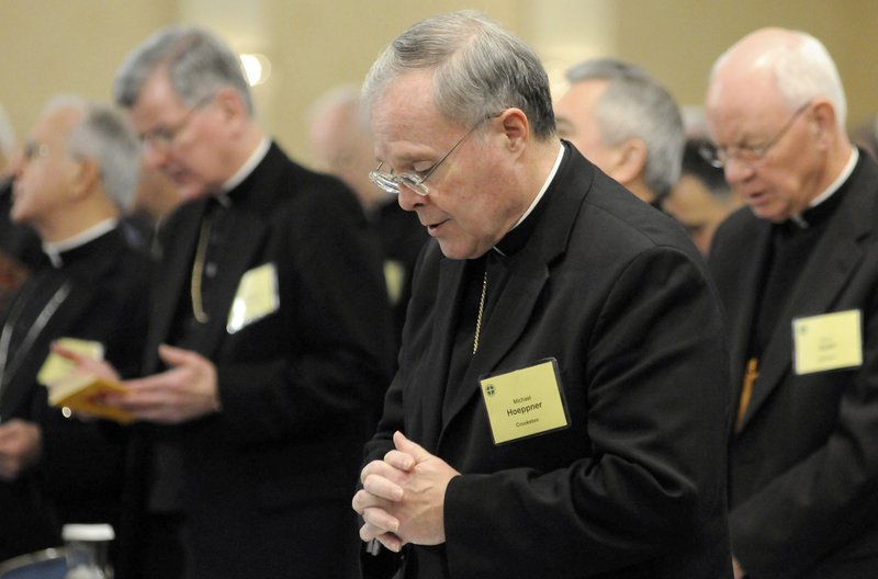 FILE - In this Monday, Nov. 10, 2008 file photo, Bishop Michael J. Hoeppner of Crookston, Minn. prays during a semi-annual meeting of the United States Conference of Catholic Bishops, in Baltimore. A Minnesota bishop who was investigated by the Vatican for allegedly interfering with past investigations into clergy sexual abuse has resigned. The Vatican said Tuesday, April 13, 2021 that Pope Francis had accepted the resignation of Crookston Bishop Michael Hoeppner and named a temporary replacement to run the dioceses. (AP Photo/ Steve Ruark, File)
