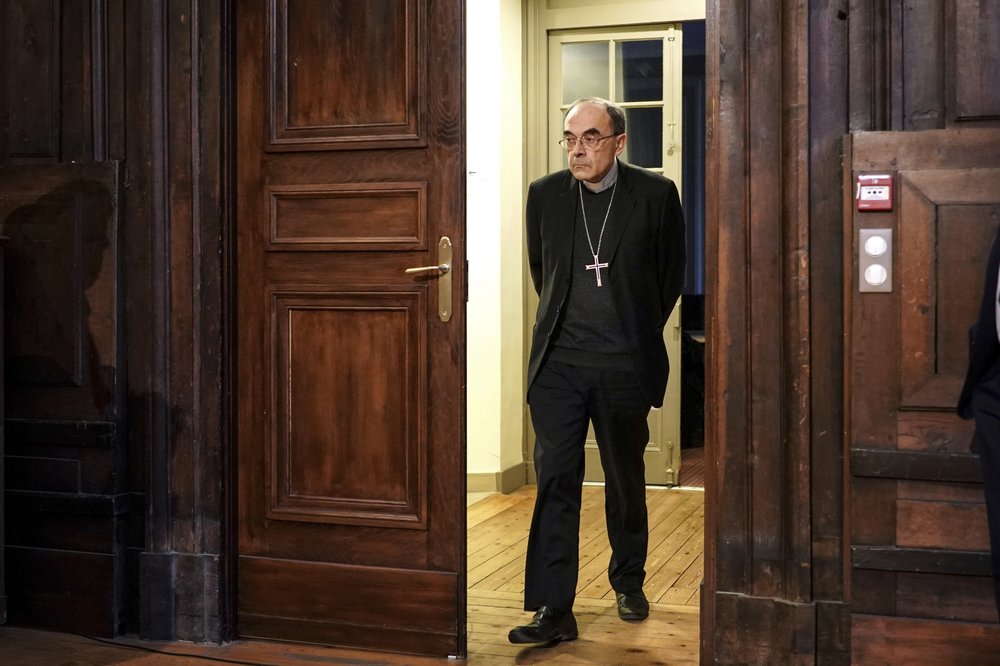 FILE - In this Thursday, Jan.30, 2020 filer, Cardinal Philippe Barbarin arrives at a press conference in Lyon, central France. France's highest court confirmed on Wednesday that the former archbishop of Lyon, Cardinal Philippe Barbarin, is not guilty of covering up the sexual crimes of a predator priest. (AP Photo/Laurent Cirpriani, File)