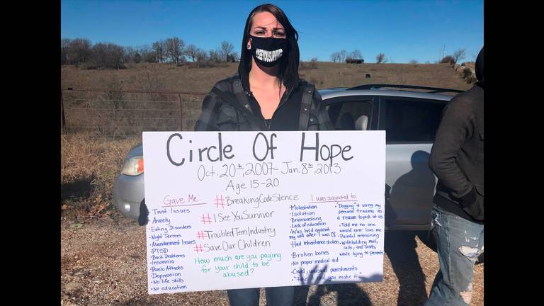 Maggie Drew attended a rally in November in Stockton, Missouri, to call attention to alleged abuses at Circle of Hope Girls Ranch and other faith-based reform schools. Her sign listed her own experiences, she said. LAURA BAUER LBAUER@KCSTAR.COM