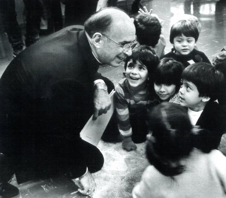 The late Chicago Cardinal Joseph Bernardin is pictured with children in an undated photo. Over a two-year period, in 1991 and 1992, the cardinal developed a comprehensive plan to address clergy sexual abuse and shared the plan with his fellow bishops, Cardinal Blase Cupich, Chicago's current cardinal-archbishop, said in an April 9, 2021, address for an international symposium on clergy sex abuse. (CNS / Courtesy of John H. White)